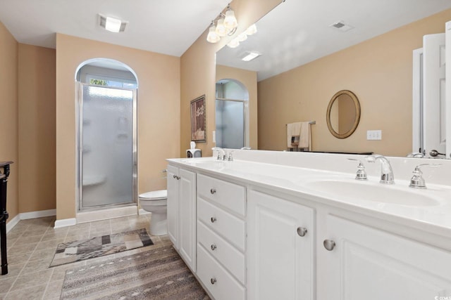 347 Kessinger Dr, Surfside Beach, SC 29575 - full bath with double vanity, a shower stall, toilet, tile patterned flooring, and baseboards