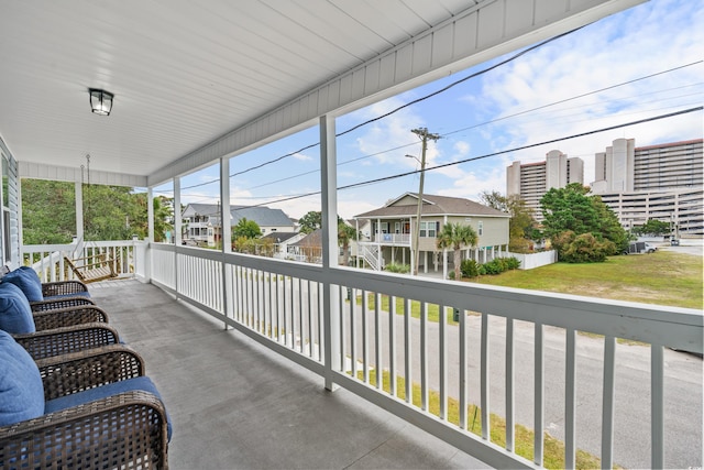 sunroom featuring a residential view