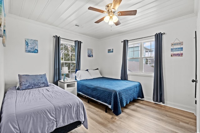 bedroom with ornamental molding, light wood-style floors, ceiling fan, and baseboards