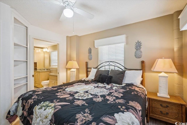 bedroom with multiple windows, connected bathroom, and a ceiling fan