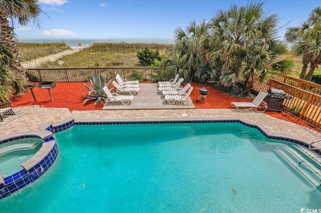 view of swimming pool with a patio, a fenced backyard, and a pool with connected hot tub