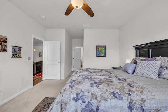 carpeted bedroom featuring baseboards and ceiling fan