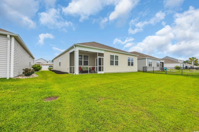 rear view of house featuring a sunroom