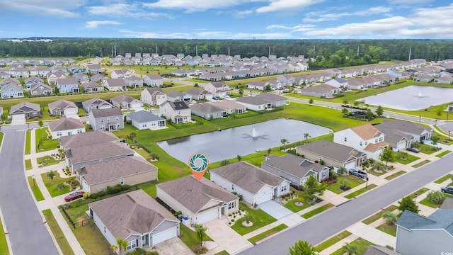 aerial view of property and surrounding area featuring nearby suburban area and a nearby body of water