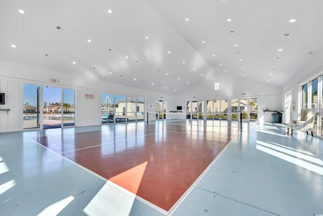 miscellaneous room with concrete flooring, high vaulted ceiling, and recessed lighting