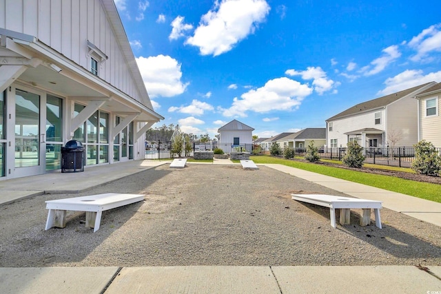 view of community featuring fence and a residential view