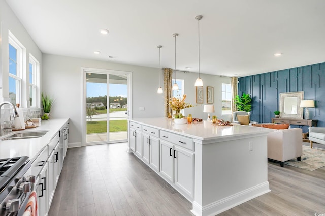 814 Belle Dr, North Myrtle Beach, SC 29582 - kitchen featuring a sink, high end range, light wood finished floors, recessed lighting, and white cabinets