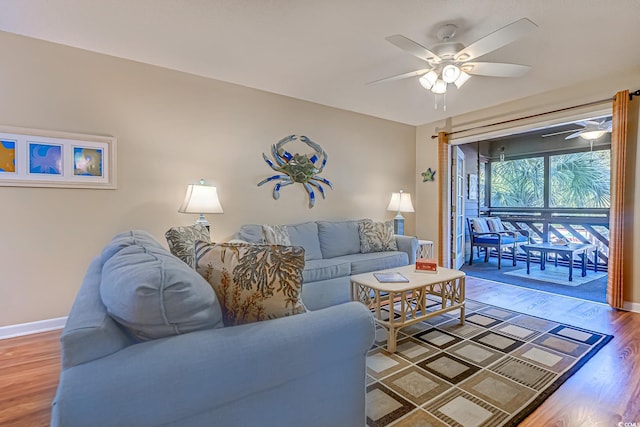 living area with ceiling fan, wood finished floors, and baseboards