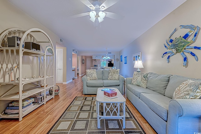 living room with ceiling fan, wood finished floors, and baseboards