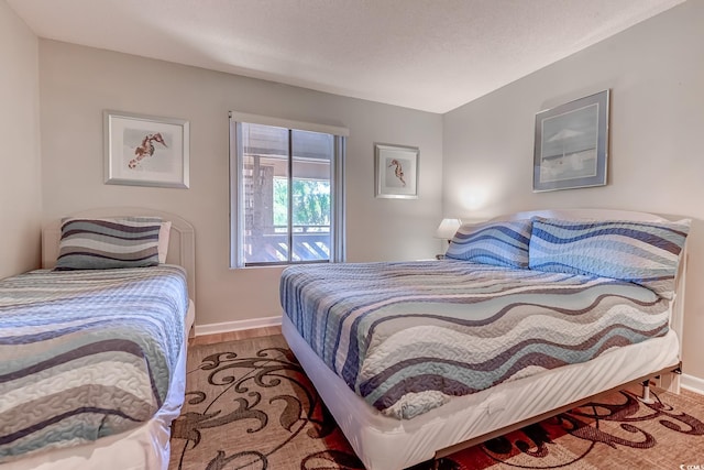 bedroom with baseboards and wood finished floors