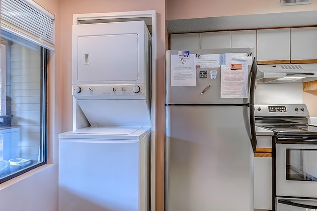 laundry area with stacked washing machine and dryer