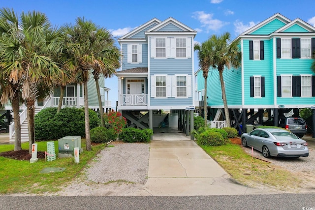 17 N Seaside Dr, Surfside Beach, SC 29575 - coastal inspired home with a carport, concrete driveway, and stairway