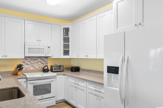 17 N Seaside Dr, Surfside Beach, SC 29575 - kitchen featuring white appliances, a sink, white cabinetry, and glass insert cabinets