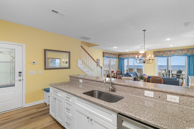 17 N Seaside Dr, Surfside Beach, SC 29575 - kitchen featuring a sink, white cabinets, a chandelier, light wood-type flooring, and pendant lighting