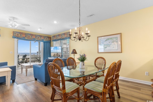 17 N Seaside Dr, Surfside Beach, SC 29575 - dining space featuring wood finished floors, a chandelier, a ceiling fan, baseboards, and recessed lighting