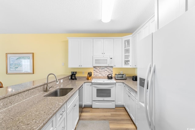 17 N Seaside Dr, Surfside Beach, SC 29575 - kitchen featuring white appliances, a sink, and white cabinetry