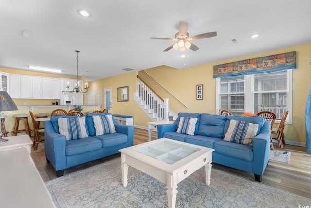 17 N Seaside Dr, Surfside Beach, SC 29575 - living area featuring a chandelier, stairs, ceiling fan, light wood-style floors, and recessed lighting