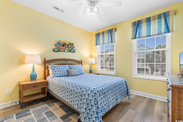 17 N Seaside Dr, Surfside Beach, SC 29575 - bedroom with wood finished floors, baseboards, and a ceiling fan