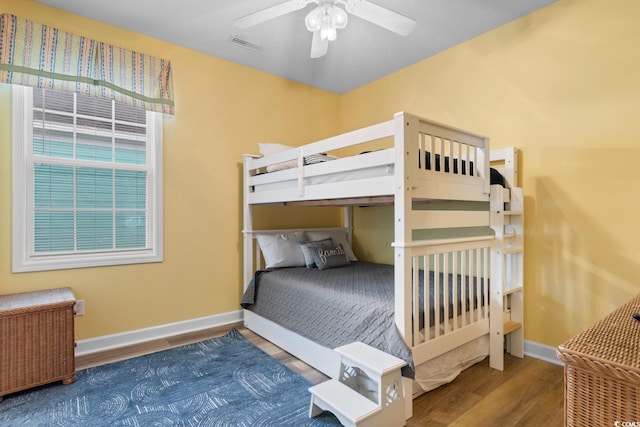 17 N Seaside Dr, Surfside Beach, SC 29575 - bedroom with wood finished floors, baseboards, and a ceiling fan