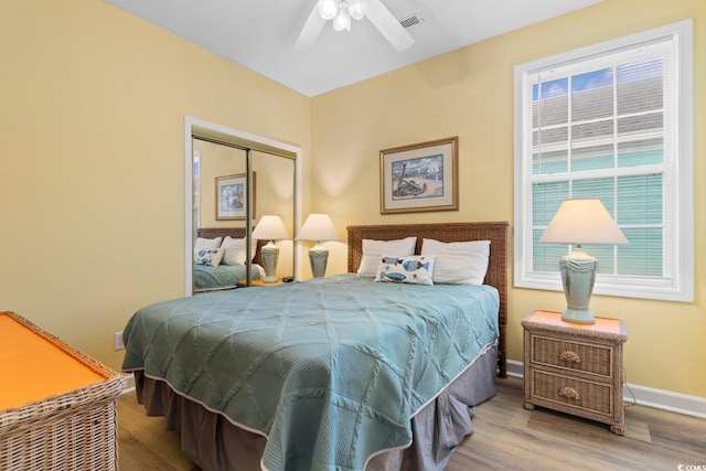 17 N Seaside Dr, Surfside Beach, SC 29575 - bedroom featuring wood finished floors, multiple windows, a closet, and baseboards