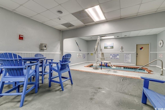 5905 S Kings Hwy Unit 1717, Myrtle Beach, SC 29575 - miscellaneous room featuring a drop ceiling, a wainscoted wall, and concrete flooring
