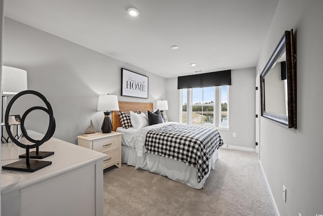 bedroom featuring light carpet, recessed lighting, and baseboards