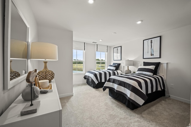 bedroom featuring light carpet, baseboards, and recessed lighting