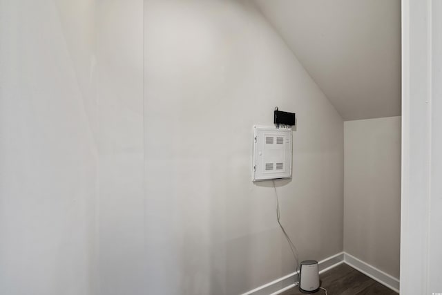 laundry room with baseboards and dark wood finished floors