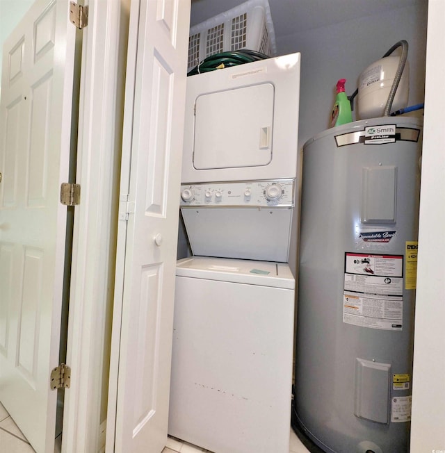 laundry room featuring water heater and stacked washer / drying machine