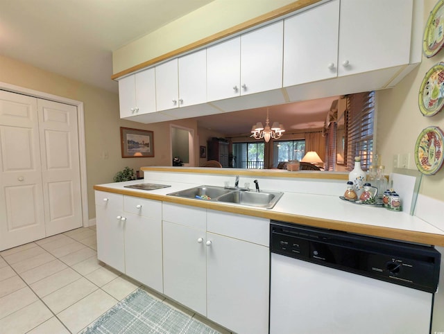 kitchen with white dishwasher, a sink, a chandelier, light tile patterned floors, and white cabinets