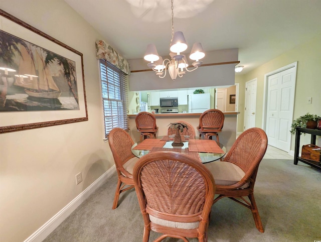 dining area with a chandelier, carpet, and baseboards
