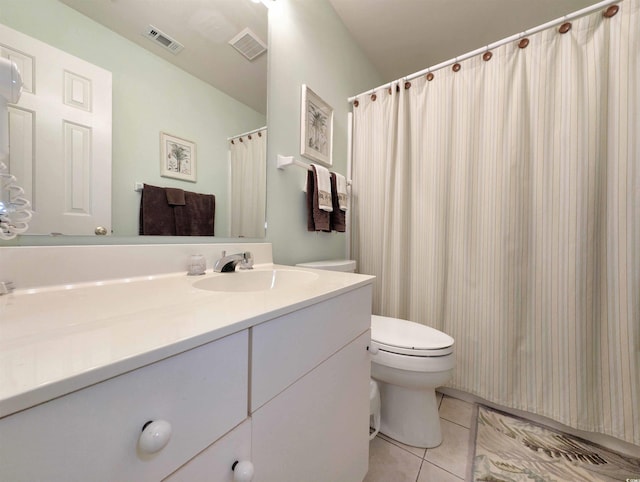 bathroom with tile patterned floors, vanity, and toilet