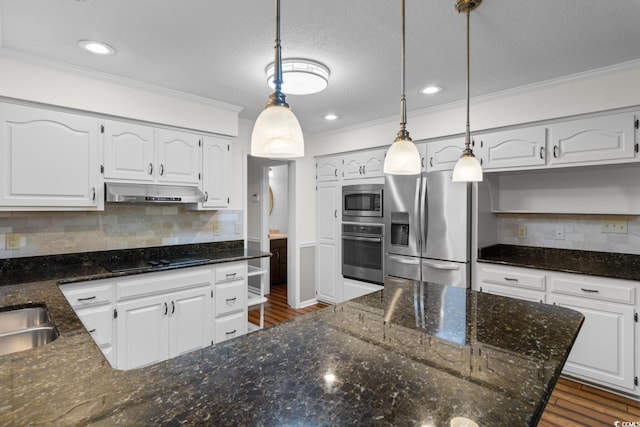 8207 Timber Ridge Rd, Conway, SC 29526 - kitchen featuring appliances with stainless steel finishes, under cabinet range hood, ornamental molding, dark wood-style flooring, and white cabinets