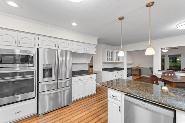 8207 Timber Ridge Rd, Conway, SC 29526 - kitchen featuring stainless steel appliances, ornamental molding, light wood finished floors, white cabinets, and decorative backsplash
