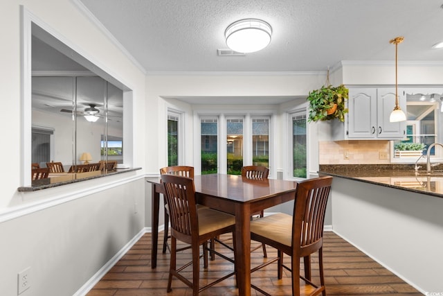 8207 Timber Ridge Rd, Conway, SC 29526 - dining area with dark wood-style flooring, ornamental molding, a ceiling fan, a textured ceiling, and baseboards