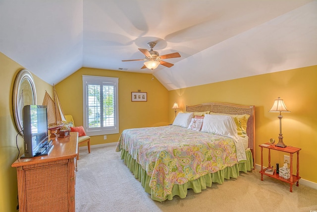 carpeted bedroom with vaulted ceiling, baseboards, and ceiling fan
