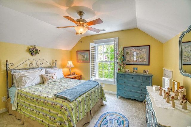 bedroom with light carpet, vaulted ceiling, baseboards, and a ceiling fan