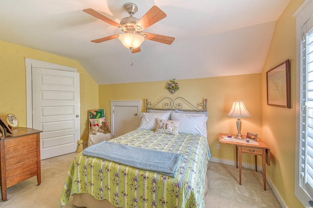 carpeted bedroom with vaulted ceiling, ceiling fan, and baseboards