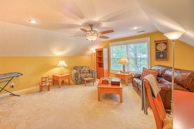 living area with lofted ceiling, a ceiling fan, and light colored carpet