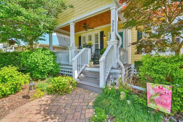 doorway to property featuring covered porch and a ceiling fan