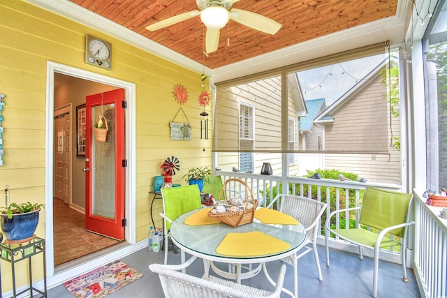 sunroom / solarium featuring a ceiling fan and healthy amount of natural light