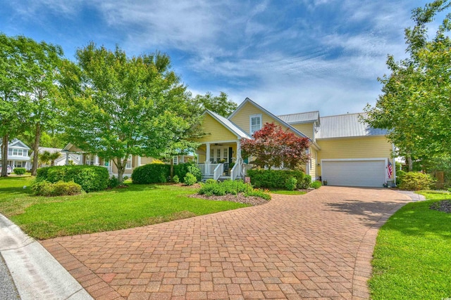 obstructed view of property featuring a porch, a front lawn, decorative driveway, and an attached garage