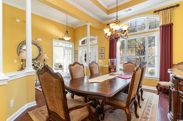 4608 Grovecrest Cir N, Myrtle Beach, SC 29582 - dining space featuring decorative columns, healthy amount of natural light, wood finished floors, a chandelier, and crown molding
