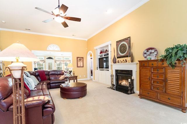 4608 Grovecrest Cir N, Myrtle Beach, SC 29582 - carpeted living area with crown molding, a ceiling fan, arched walkways, a fireplace with flush hearth, and baseboards