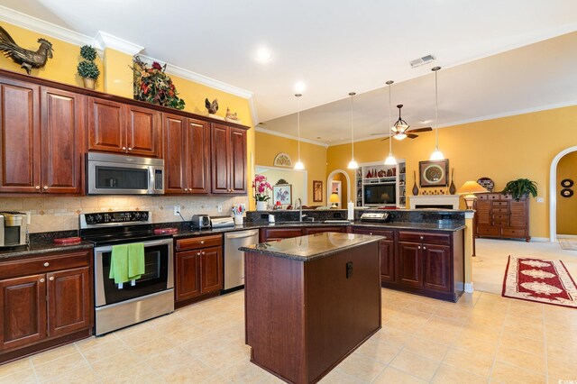 4608 Grovecrest Cir N, Myrtle Beach, SC 29582 - kitchen featuring appliances with stainless steel finishes, a peninsula, light tile patterned flooring, crown molding, and a center island