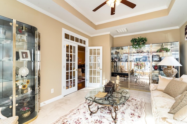 4608 Grovecrest Cir N, Myrtle Beach, SC 29582 - carpeted living room featuring french doors, ceiling fan, a tray ceiling, and ornamental molding