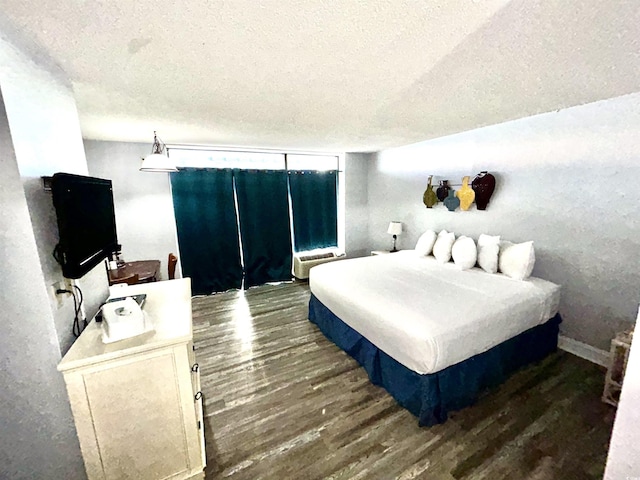 1905 S Ocean Blvd Unit 922-924, Myrtle Beach, SC 29577 - bedroom featuring a textured ceiling and wood finished floors