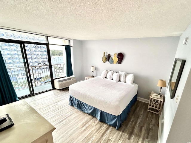 1905 S Ocean Blvd Unit 922-924, Myrtle Beach, SC 29577 - bedroom with wood finished floors, a wall of windows, access to exterior, and a textured ceiling