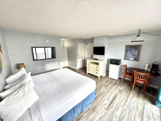 1905 S Ocean Blvd Unit 922-924, Myrtle Beach, SC 29577 - bedroom with wood finished floors and a textured ceiling
