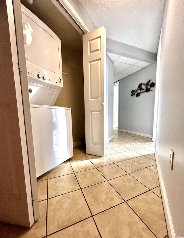 1905 S Ocean Blvd Unit 922-924, Myrtle Beach, SC 29577 - washroom featuring stacked washer / dryer and light tile patterned floors